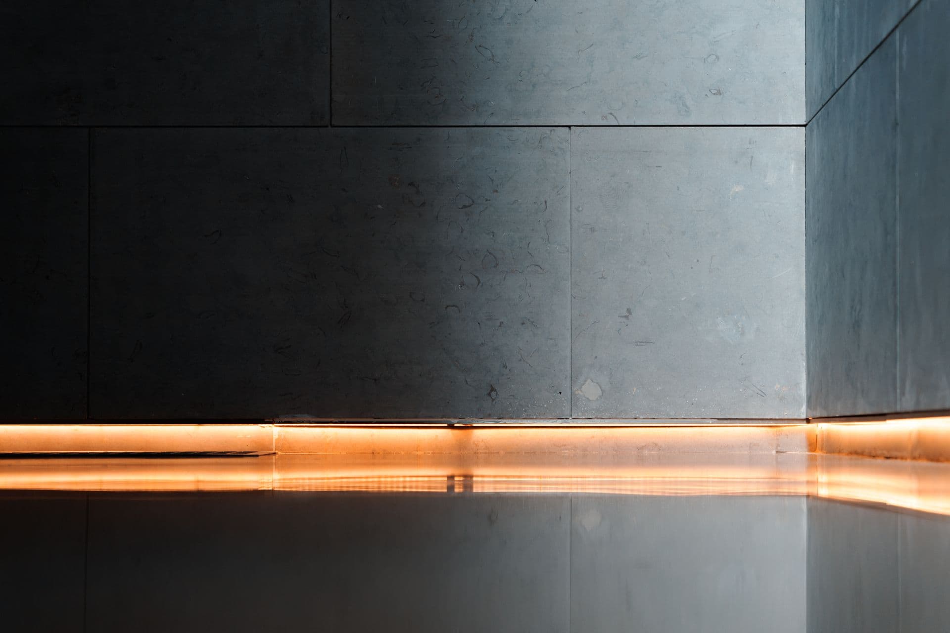 Warm light reflecting across a seamless high-gloss resin floor
